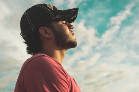 Mindfulness - Man Wearing Black Cap With Eyes Closed Under Cloudy Sky