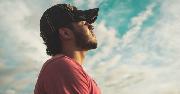 Mindfulness - Man Wearing Black Cap With Eyes Closed Under Cloudy Sky