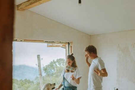 Room Renovation - A Happy Couple Dancing With Their Dog