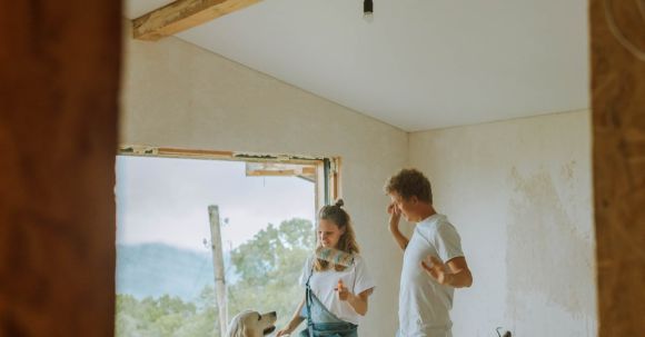 Room Renovation - A Happy Couple Dancing With Their Dog