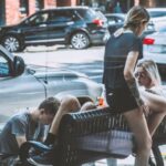 Neighborhood - Woman Siting on Bench Near on Man