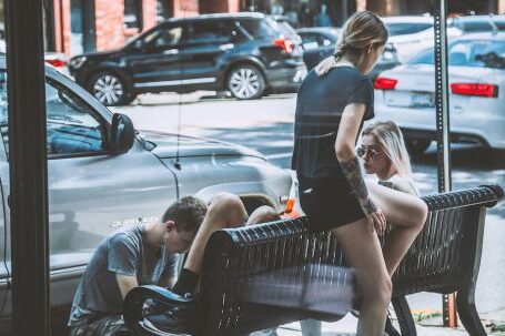 Neighborhood - Woman Siting on Bench Near on Man