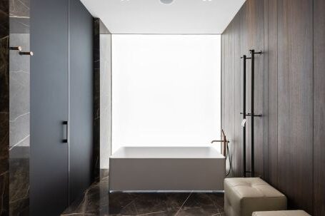Luxury Properties - Spacious bathroom interior design with leather poufs