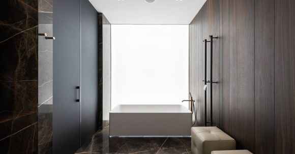 Luxury Properties - Spacious bathroom interior design with leather poufs