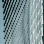 Contemporary Architecture - Monochrome Blue Grey Photo of Steel and Glass Skyscraper with Concave Facade
