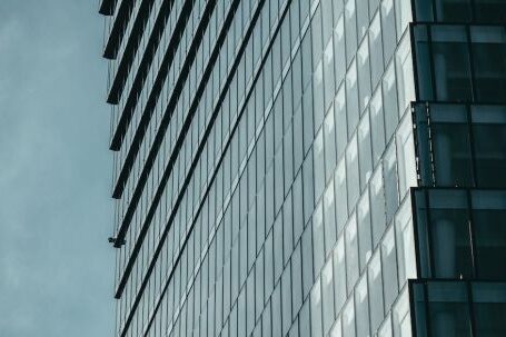 Contemporary Architecture - Monochrome Blue Grey Photo of Steel and Glass Skyscraper with Concave Facade