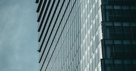 Contemporary Architecture - Monochrome Blue Grey Photo of Steel and Glass Skyscraper with Concave Facade