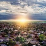 Neighborhood - Aerial Photography of Buildings Under Blue and White Sky during Golden Hour
