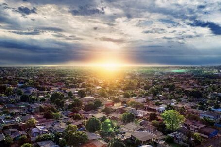 Neighborhood - Aerial Photography of Buildings Under Blue and White Sky during Golden Hour