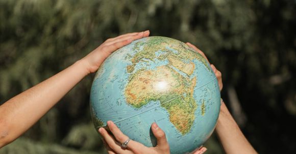 Eco Travel - People Holding a Globe