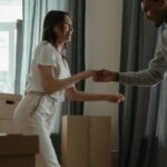 New Home - Man in White Dress Shirt and Black Pants Standing Beside Woman in White Long Sleeve Shirt