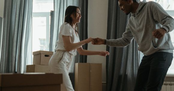 New Home - Man in White Dress Shirt and Black Pants Standing Beside Woman in White Long Sleeve Shirt