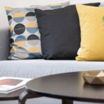 New Home - Centerpiece on Coffee Table Beside Sofa With Three Pillows