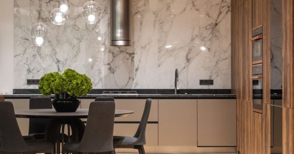 Luxury Properties - Interior of stylish kitchen with minimalist furniture and round table with chairs