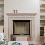 Luxury Properties - Interior of modern living room with armchairs on carpet near table next to marble pink fireplace