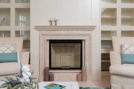 Luxury Properties - Interior of modern living room with armchairs on carpet near table next to marble pink fireplace