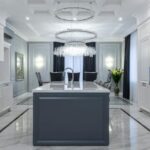 Luxury Properties - Interior of contemporary spacious kitchen with light expensive furniture placed in apartment with minimalistic design