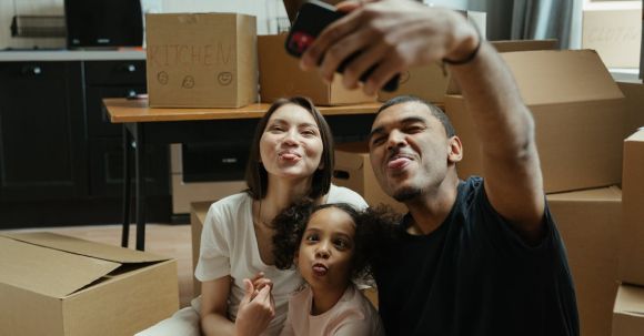 New Home - Man in Black Crew Neck Shirt Holding Girl in Pink Long Sleeve Shirt