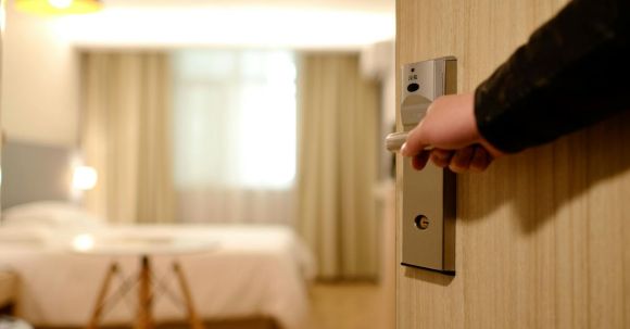 New Home - Person Holding on Door Lever Inside Room