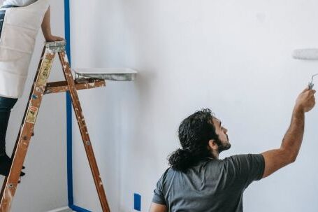 New Home - A Couple Painting The Wall