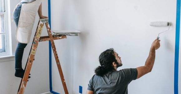 New Home - A Couple Painting The Wall