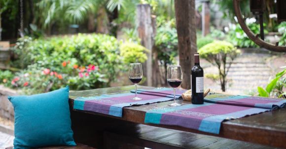 Backyard - Wine Bottle and Glasses on Purple Mat