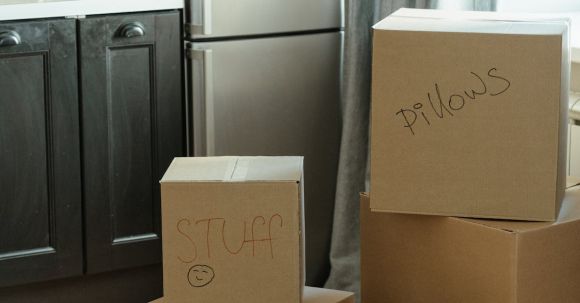 New Home - Brown Cardboard Boxes on White Wooden Cabinet