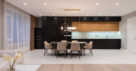 Luxury Properties - House with table with chairs near open kitchen and couch