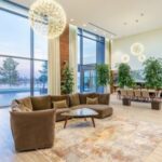 Luxury Properties - Spacious lobby with sofa near stairs and glass transparent wall