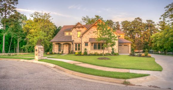 Home Exterior - Brown Brick House Beside Trees