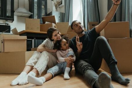 New Home - Woman in Black Shirt and Black Pants Sitting on Brown Sofa Chair