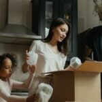 New Home - Man in Black Crew Neck Shirt Holding Girl in White Long Sleeve Shirt