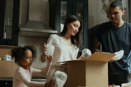 New Home - Man in Black Crew Neck Shirt Holding Girl in White Long Sleeve Shirt