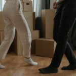 New Home - Man in White T-shirt and Black Pants Holding Woman in White T-shirt